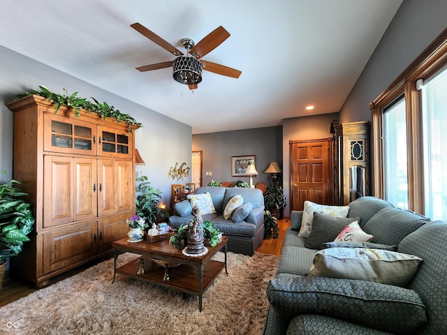 living room with hardwood / wood-style flooring and ceiling fan