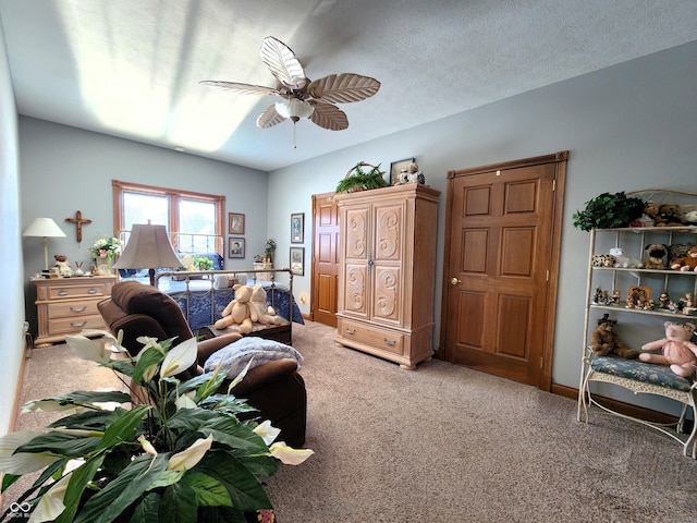 carpeted bedroom featuring a textured ceiling and ceiling fan