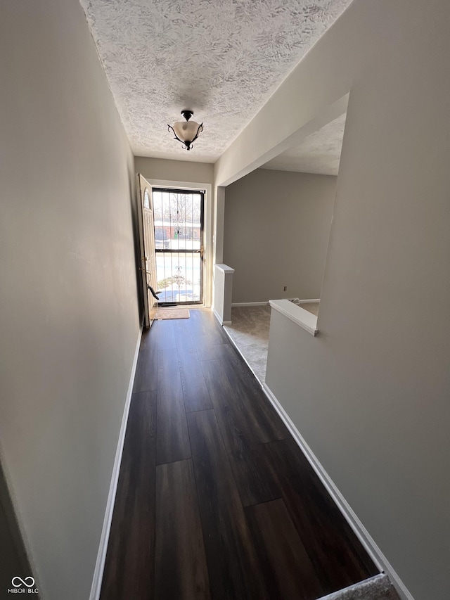 interior space featuring dark hardwood / wood-style floors and a textured ceiling