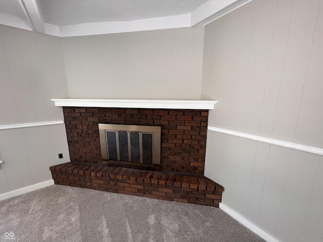 details with carpet flooring, a textured ceiling, and a fireplace