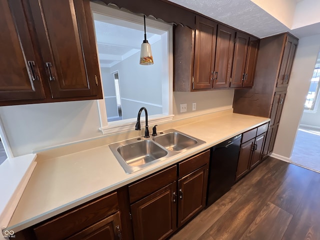 kitchen with sink, dishwasher, dark hardwood / wood-style floors, dark brown cabinetry, and decorative light fixtures