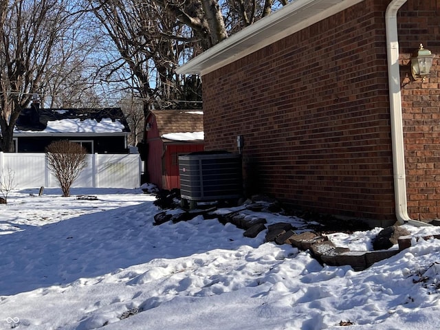 view of snowy exterior featuring cooling unit