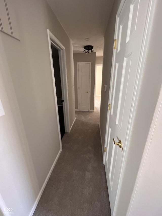 hallway with dark carpet