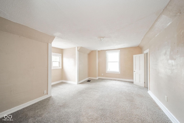 interior space with carpet floors and a textured ceiling