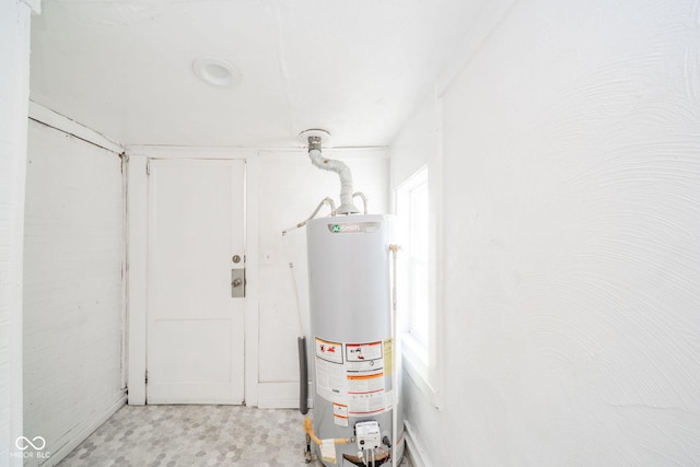 utility room featuring gas water heater