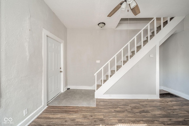 foyer entrance featuring wood-type flooring, ceiling fan, and a textured ceiling