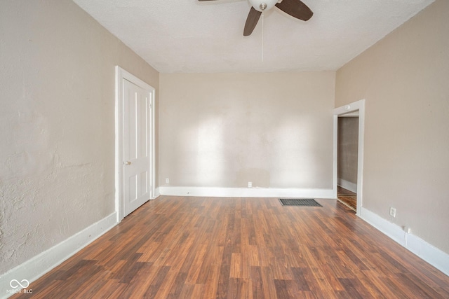 unfurnished room featuring ceiling fan and dark hardwood / wood-style flooring