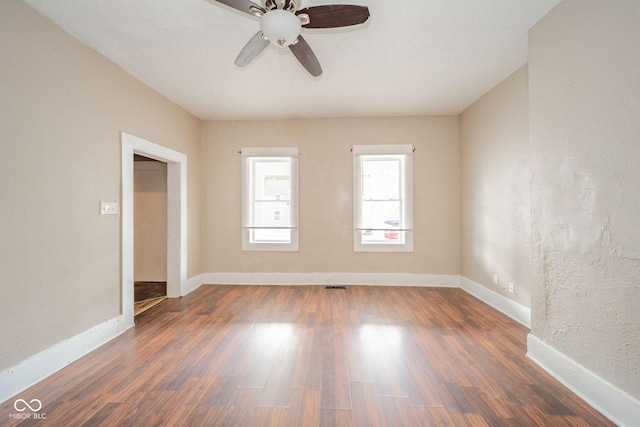 unfurnished room featuring dark hardwood / wood-style flooring and ceiling fan