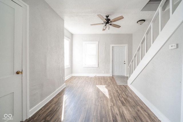 interior space with dark hardwood / wood-style floors and ceiling fan