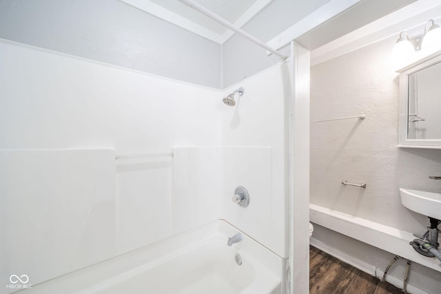 bathroom with  shower combination, toilet, and hardwood / wood-style floors