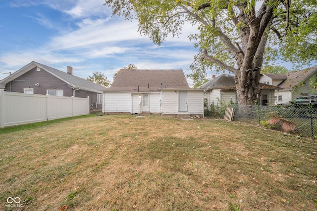 rear view of house with a lawn