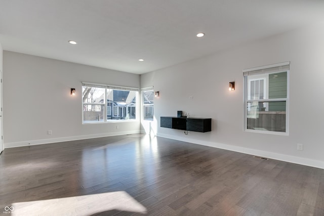 empty room with dark wood-type flooring