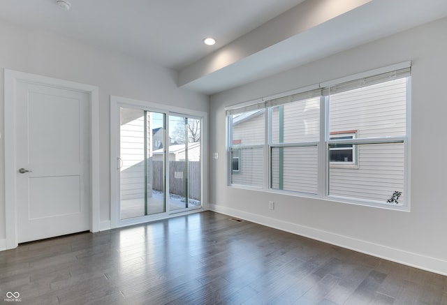 empty room featuring dark hardwood / wood-style flooring