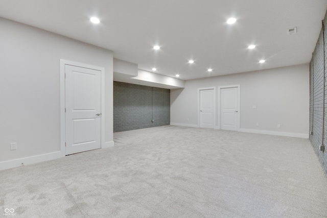 basement featuring light colored carpet