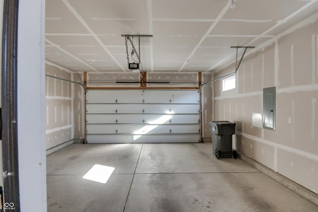 garage with a garage door opener and electric panel