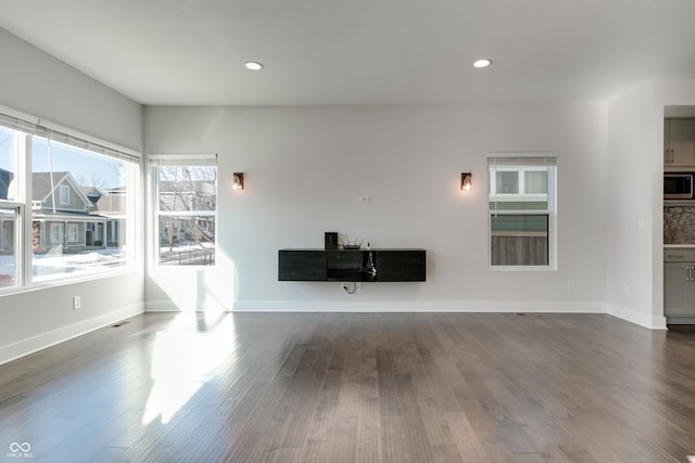 unfurnished living room featuring dark wood-type flooring