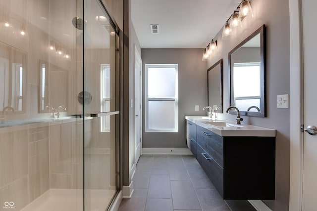 bathroom featuring walk in shower, tile patterned floors, vanity, and a wealth of natural light