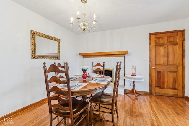 dining room featuring a notable chandelier and light hardwood / wood-style flooring