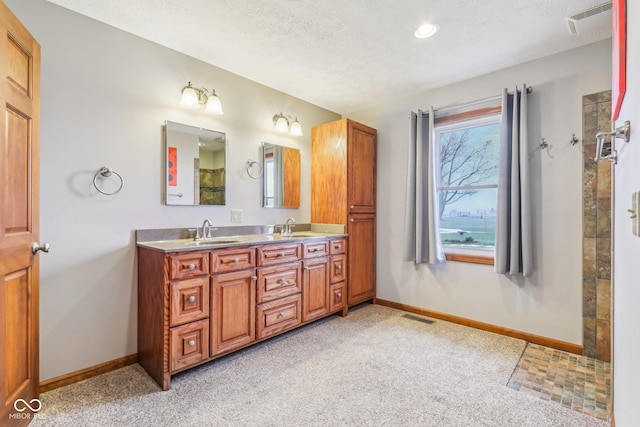 bathroom featuring vanity and a textured ceiling