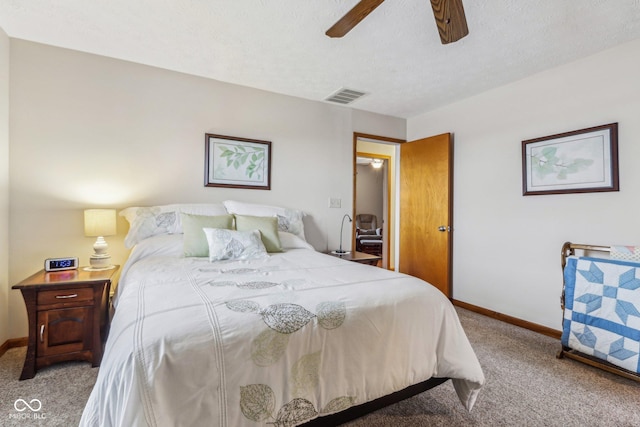 carpeted bedroom with a textured ceiling and ceiling fan