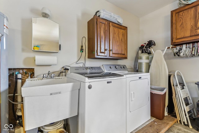 laundry area featuring independent washer and dryer, sink, and cabinets