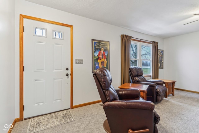 carpeted entrance foyer with a textured ceiling