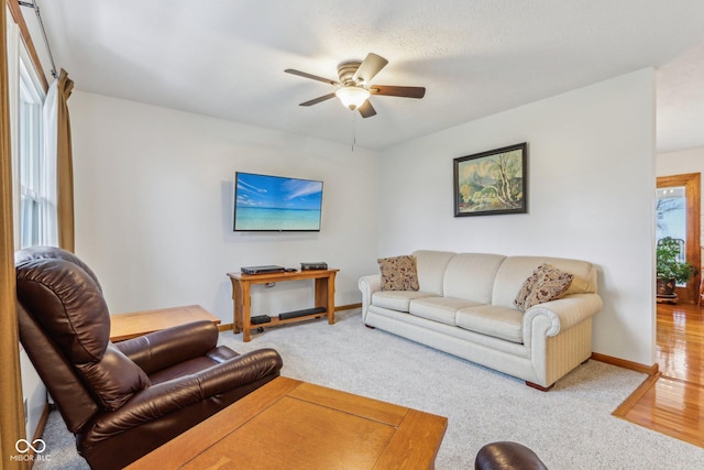 living room featuring ceiling fan and carpet floors