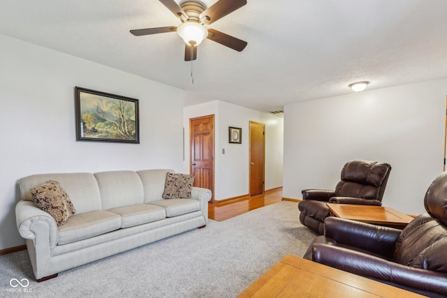 living room with carpet flooring and ceiling fan