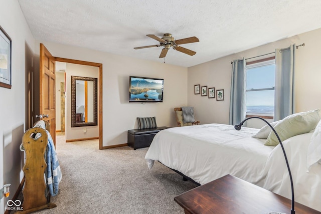 bedroom with light carpet, ceiling fan, and a textured ceiling