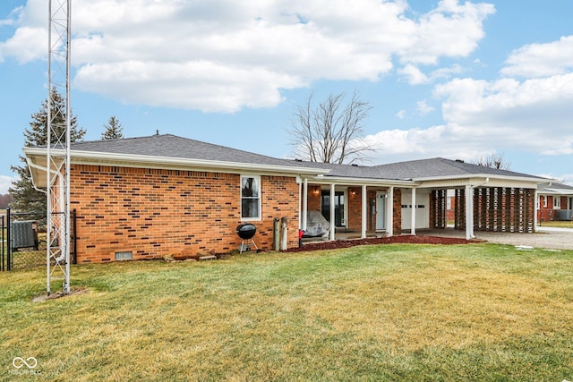 back of property with cooling unit, a carport, and a lawn