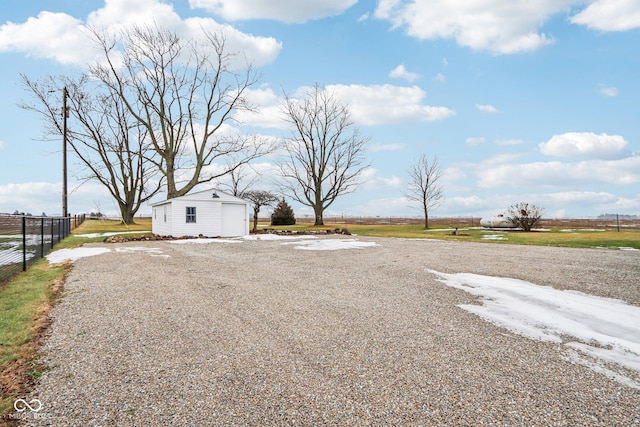 view of yard featuring a garage and an outdoor structure