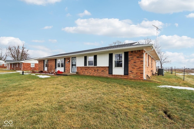 single story home with cooling unit and a front lawn