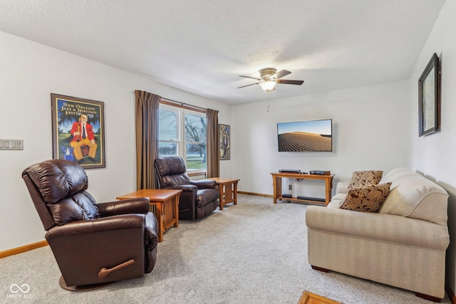 living room with ceiling fan, carpet flooring, and a textured ceiling