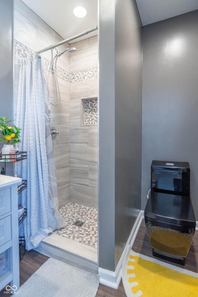 bathroom featuring vanity, hardwood / wood-style floors, and curtained shower