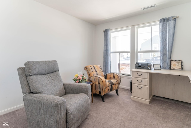 sitting room featuring light colored carpet