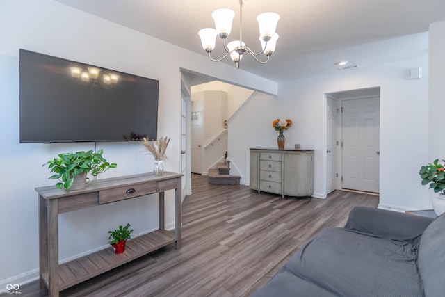 living room featuring hardwood / wood-style floors and a notable chandelier