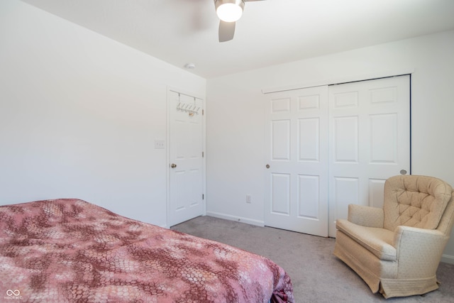 carpeted bedroom featuring a closet and ceiling fan