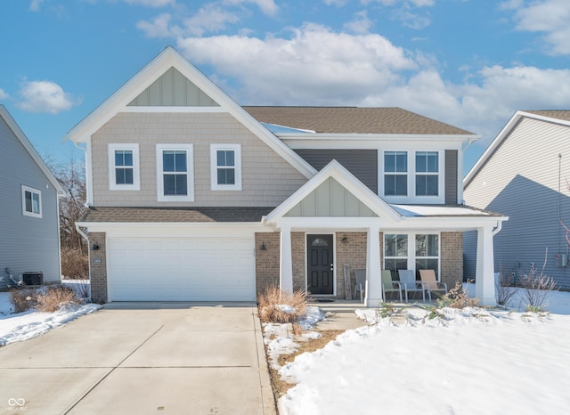 view of front of home featuring cooling unit, a garage, and covered porch