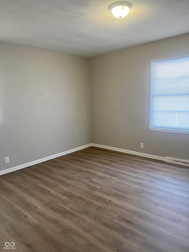 spare room featuring dark hardwood / wood-style floors