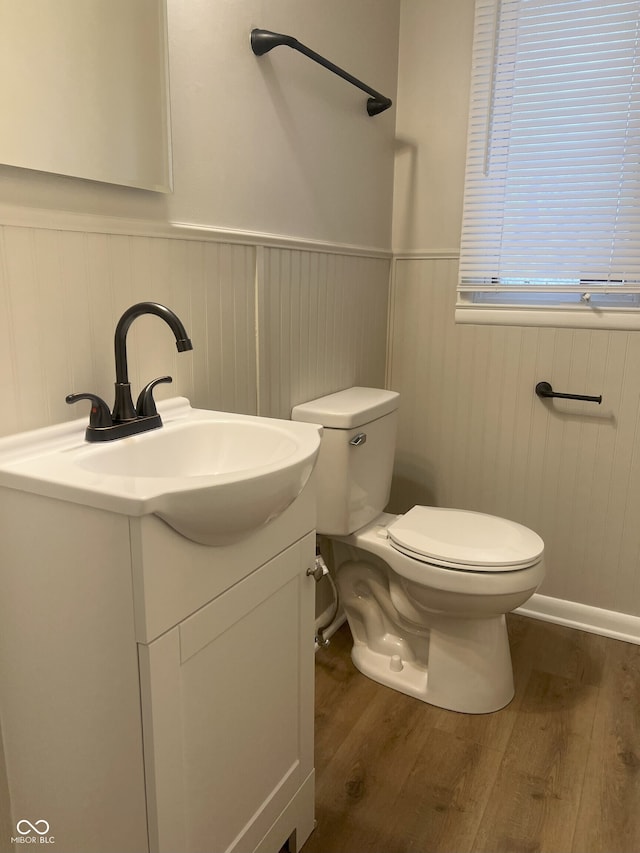 bathroom featuring vanity, hardwood / wood-style floors, and toilet