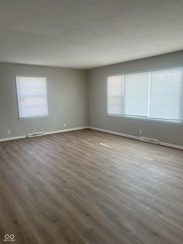 unfurnished room with hardwood / wood-style floors