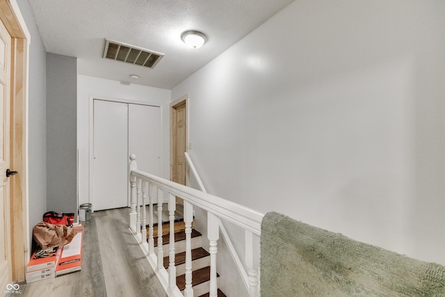 5378 E County Road 600 S, Walton, IN 46994 - corridor featuring wood finished floors, an upstairs landing, and a textured ceiling