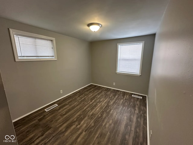 spare room featuring dark hardwood / wood-style flooring