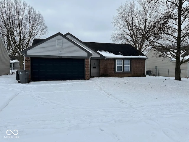 single story home with cooling unit and a garage