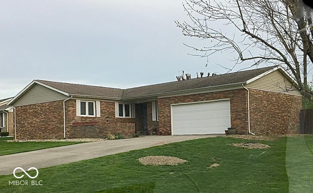 ranch-style home with a garage and a front yard