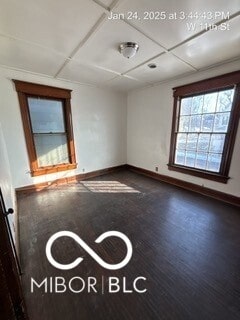 spare room featuring dark wood-type flooring