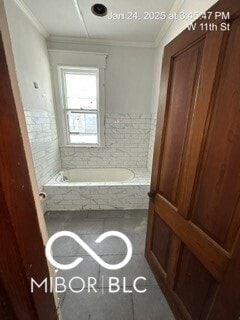 bathroom featuring tile patterned floors and a bathing tub