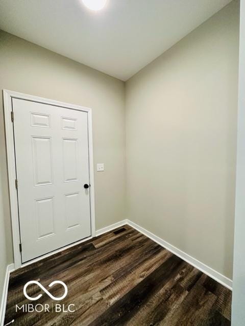 doorway with dark hardwood / wood-style floors