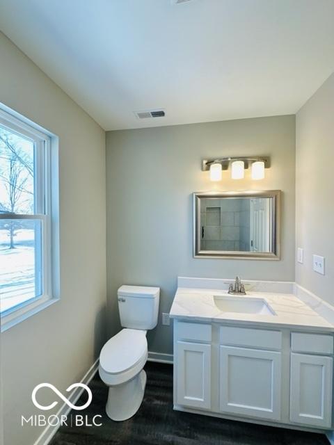 bathroom featuring vanity and toilet