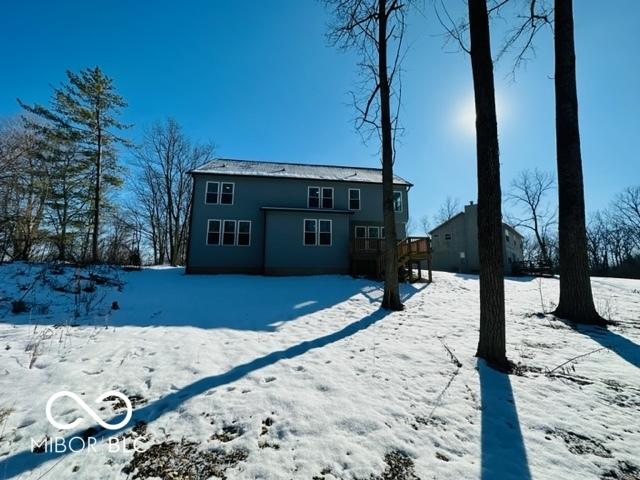 snow covered property with a deck